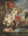 Roses, lillies, tulips, poppies and other flowers in a vase in a classical garden - John Wainwright